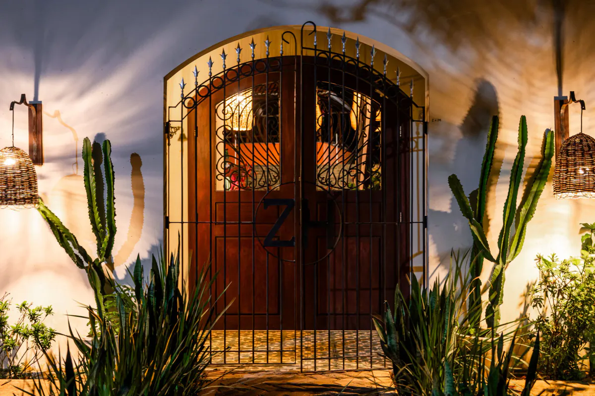 The illuminated arched entrance to Zenhouse Pipa at night